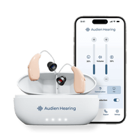 Audien Ion Pro hearing aids in charging case next to smartphone app interface for volume control
